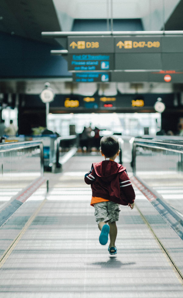 child running airport flying children