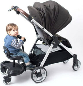 child using buggy board with seat attached to pushchair